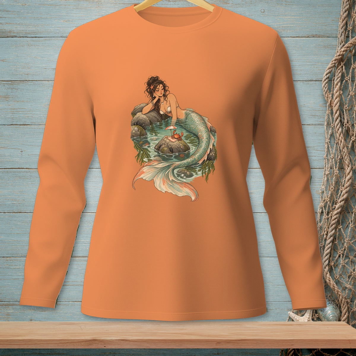 Long-sleeved orange shirt with a mermaid and crab illustration.