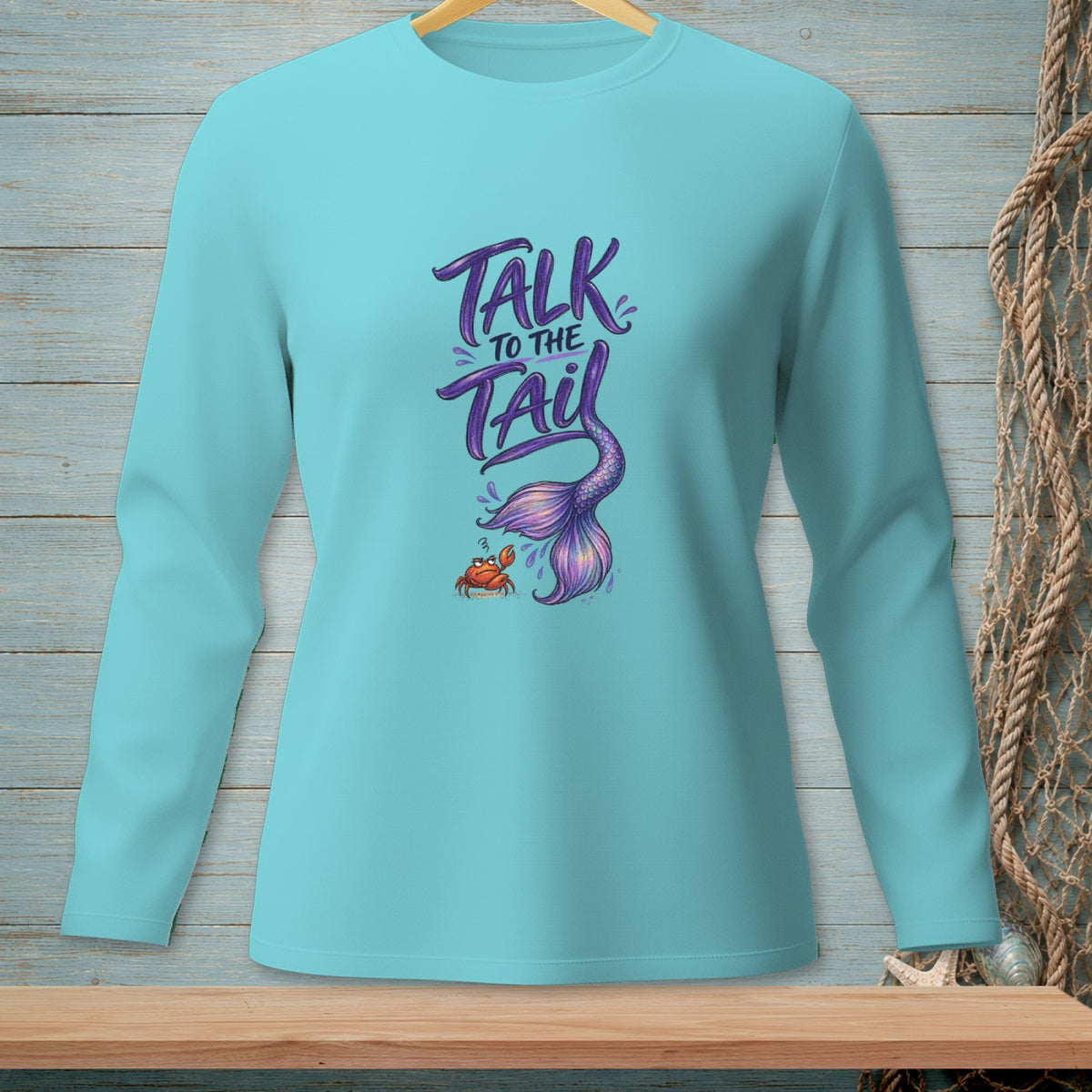 Long sleeve turquoise shirt with "Talk to the Tail" and a mermaid tail and crab graphic.
