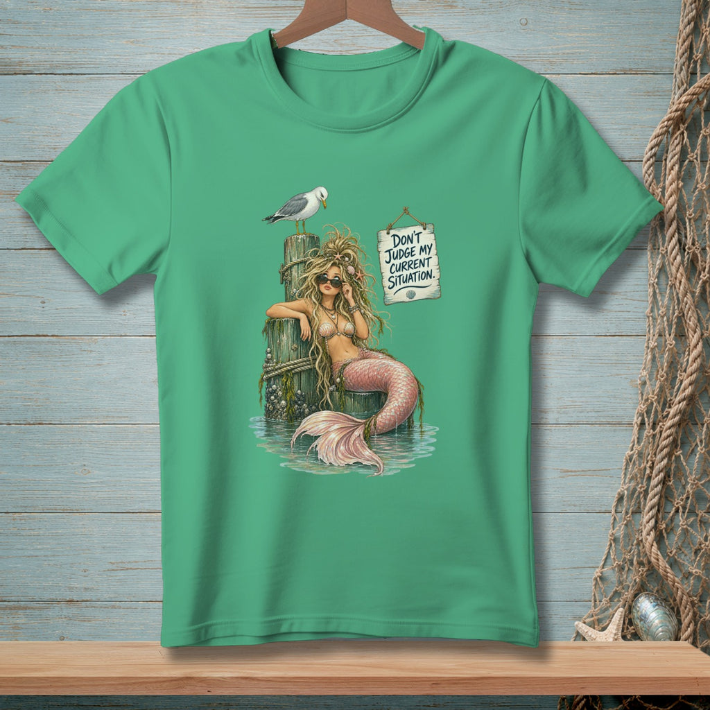 Green t-shirt with a mermaid graphic and the text "Don't Judge My Current Situation".