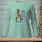 Mermaid with purple tail sitting on dock, holding drink, text "SEA HAIR ZERO CARE".