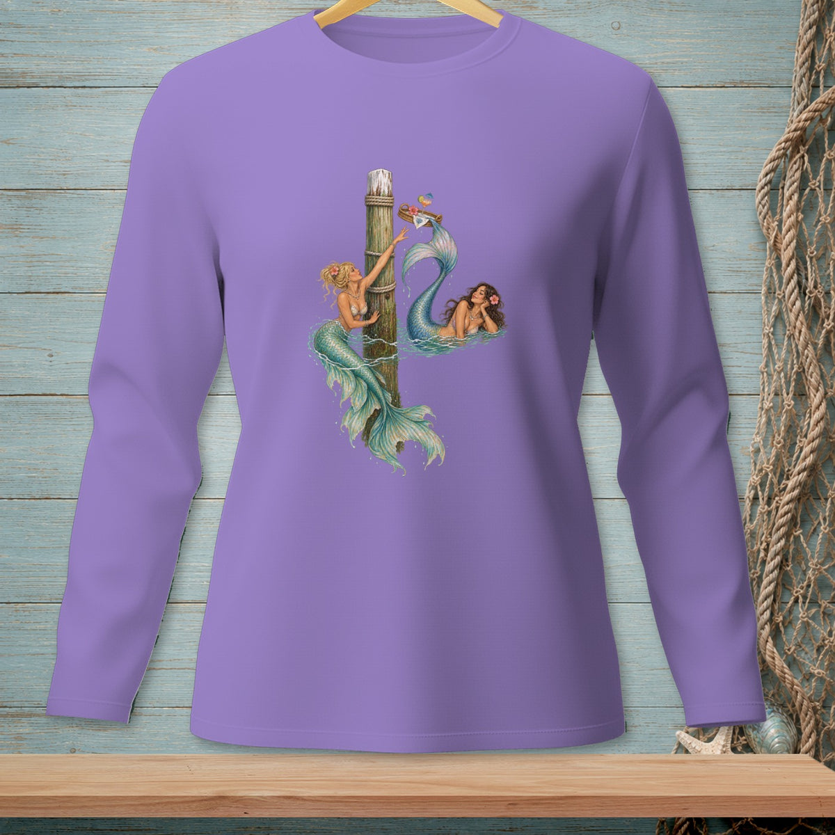 Lavender long sleeve shirt with two mermaids and a wooden post graphic.