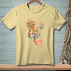 Light yellow t-shirt with a mermaid holding a cocktail and text that reads "BAD HAIR GOOD POUR".