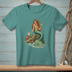 Mermaid on a rock with a crab, holding a drink, on a teal t-shirt.