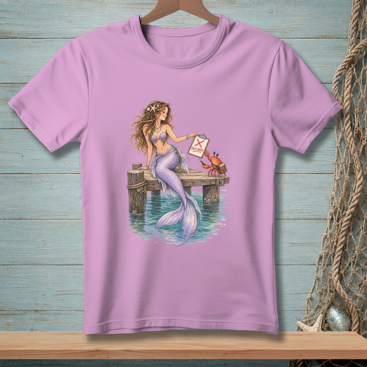 Mermaid holding clipboard with "DECLINED" and crab on a pier.