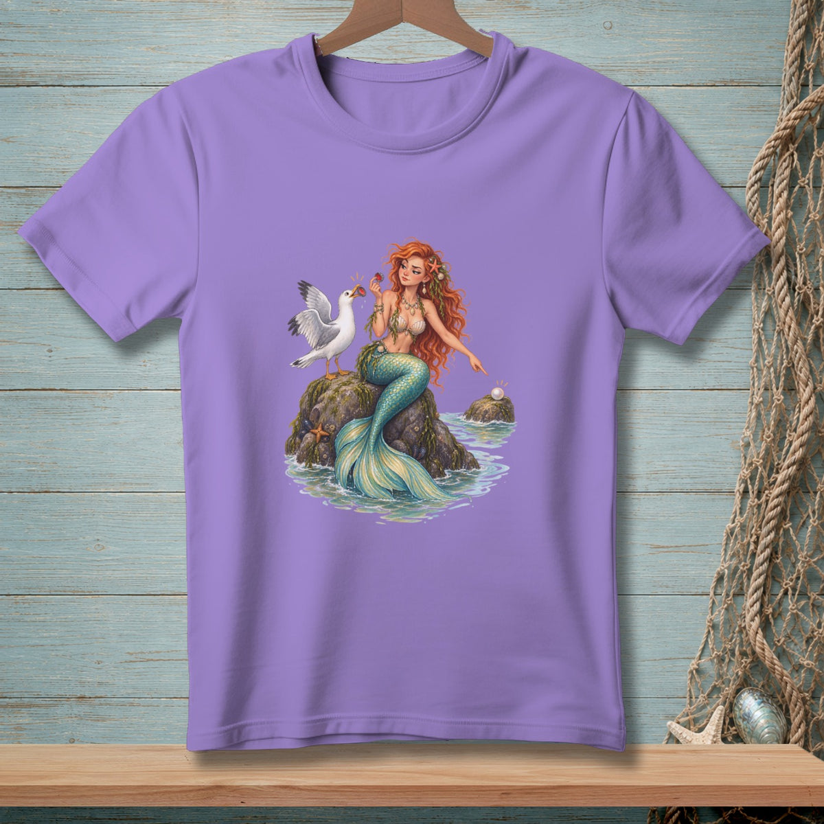 Purple t-shirt featuring a mermaid, seagull, and a pearl on a rock.