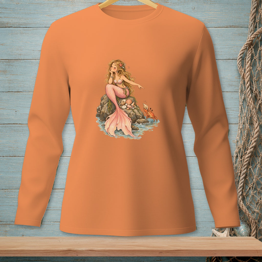 Orange long-sleeve shirt with a detailed illustration of a pink mermaid sitting on rocks with a crab.
