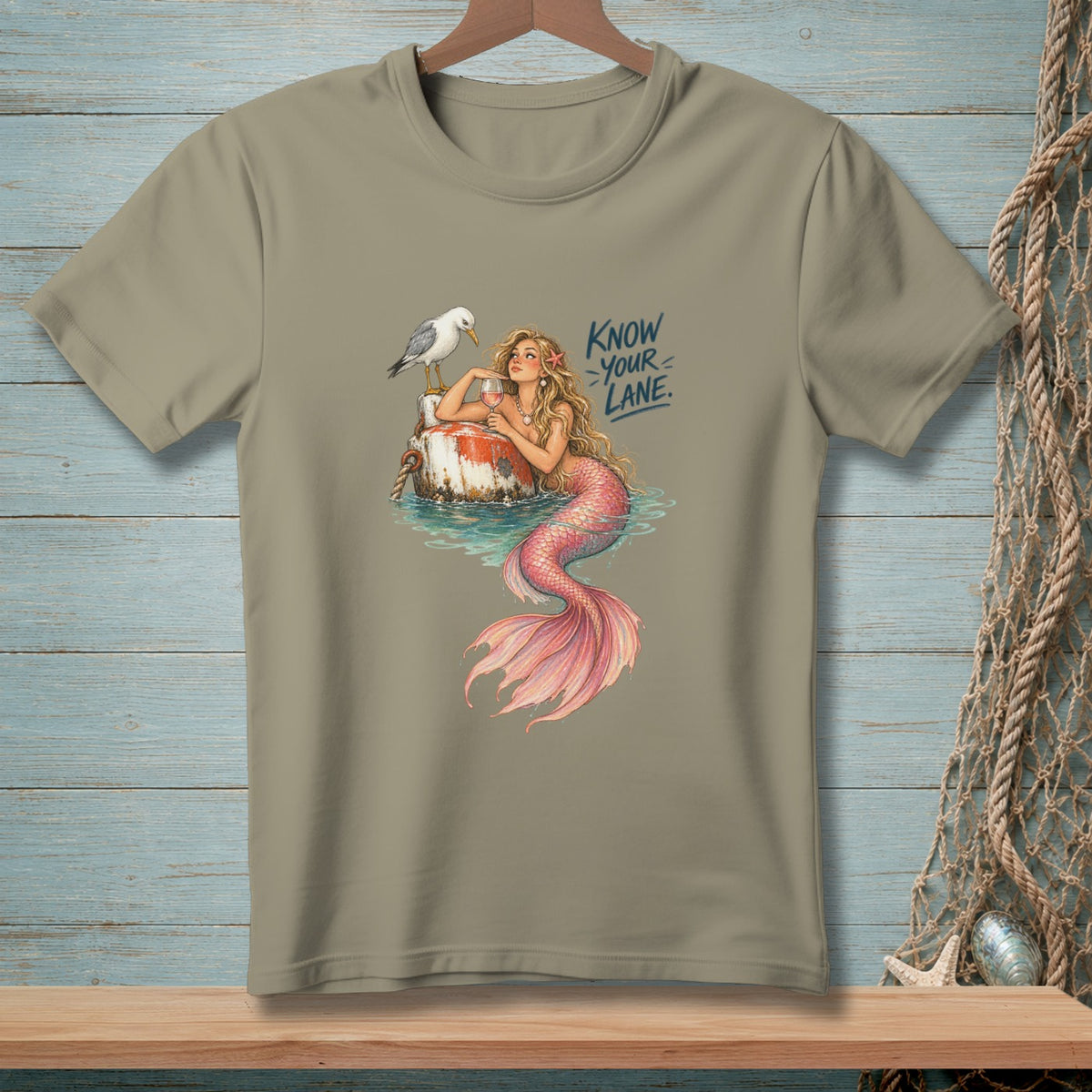 Mermaid with pink tail holding a glass, seagull on a buoy, "Know Your Lane" text.