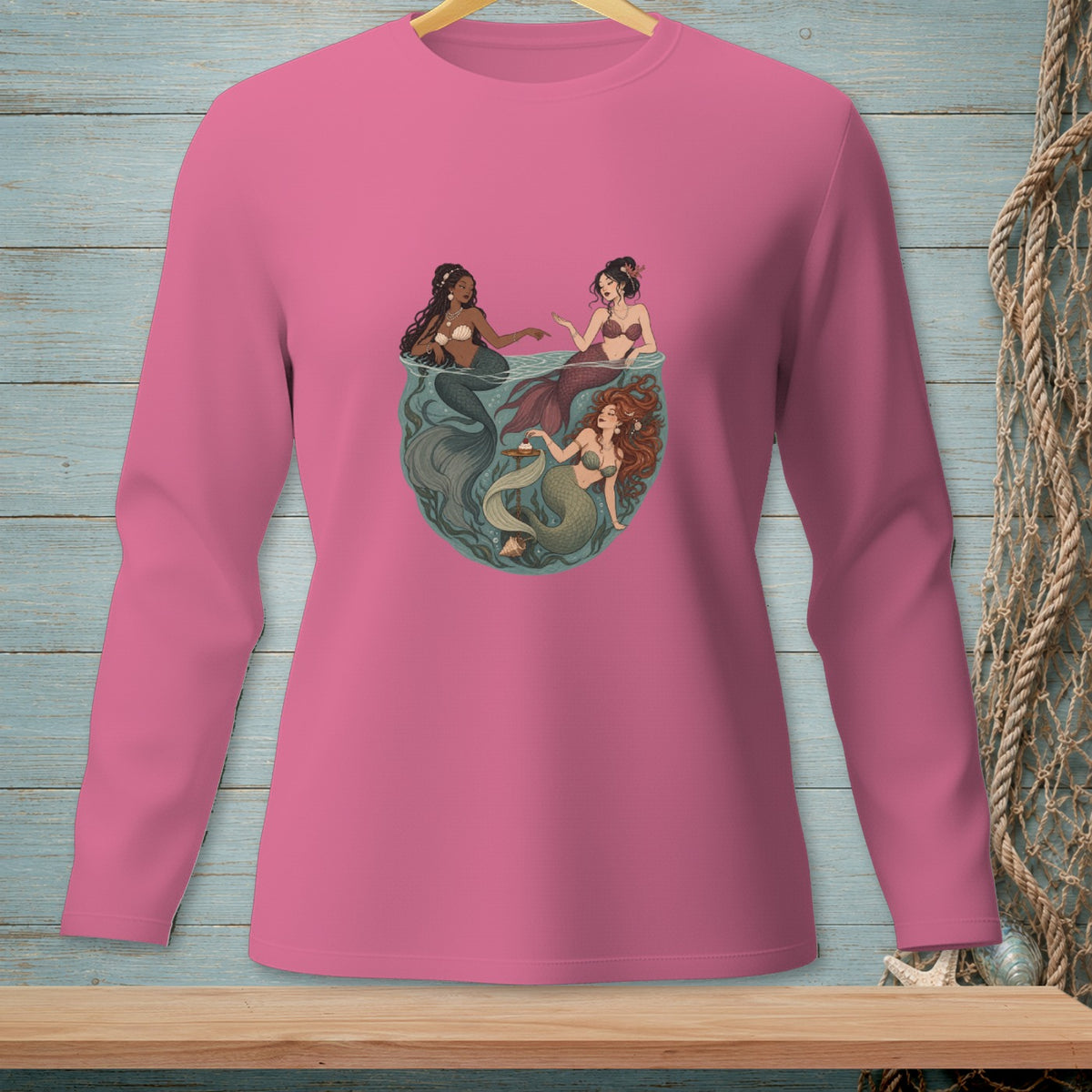 Three mermaids in a fishbowl with seaweed and shells.