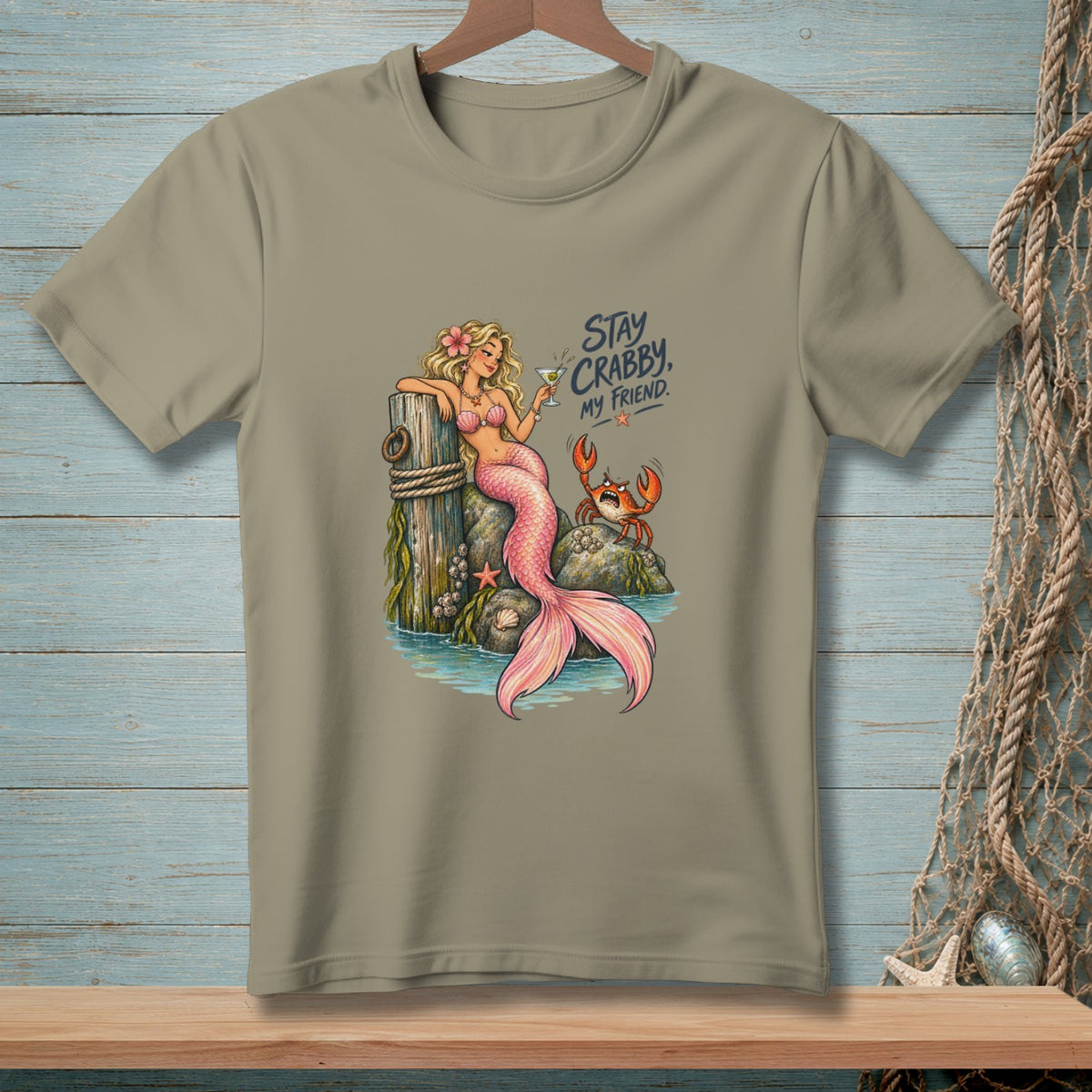 Mermaid with crab and text "Stay Crabby, My Friend" on a tan t-shirt.