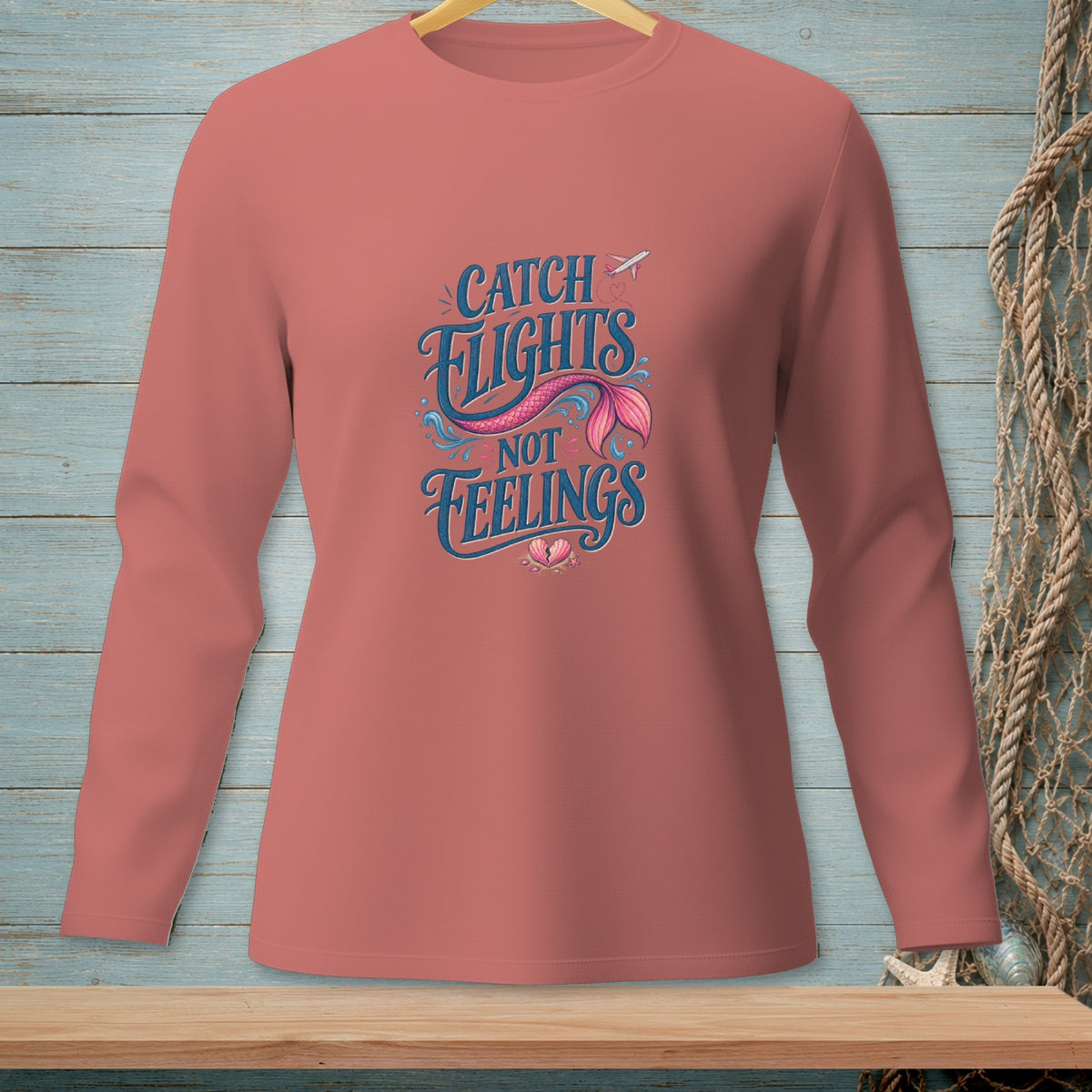 Long-sleeve shirt with "Catch Flights Not Feelings" text and mermaid tail graphic.