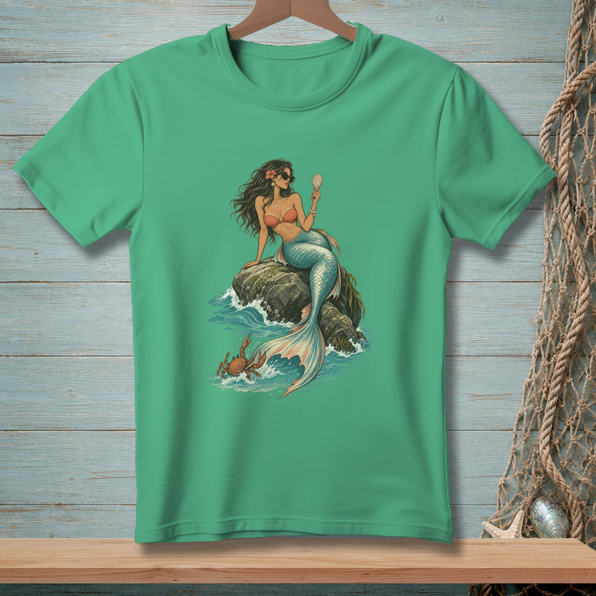 Mermaid with sunglasses holds a seashell, sitting on a rock with a crab nearby.