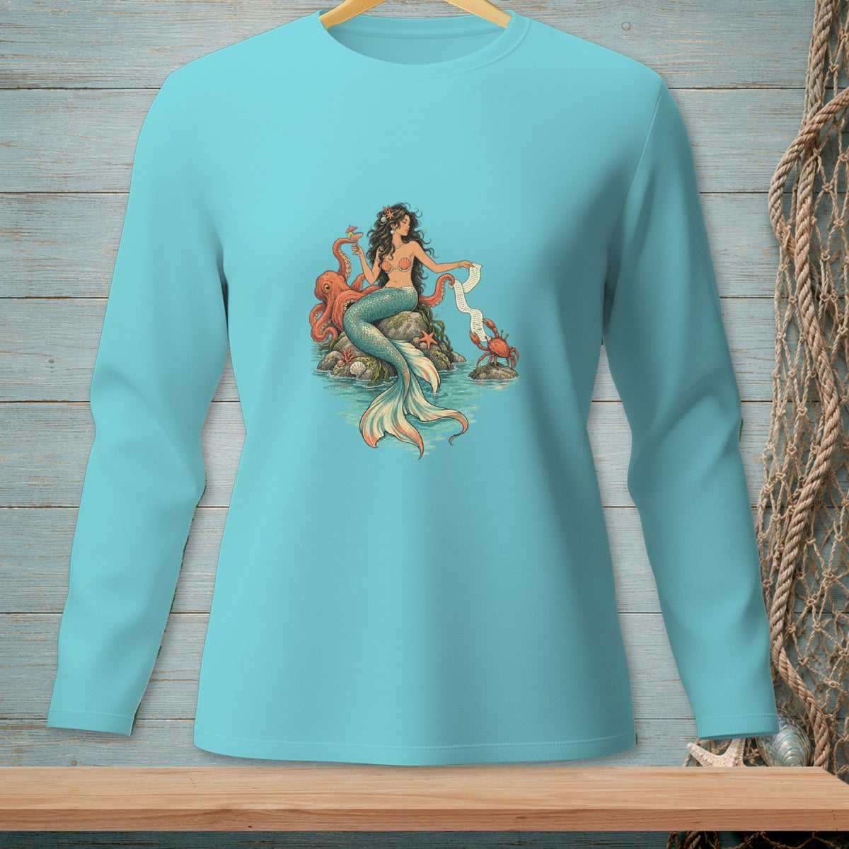 Turquoise long-sleeve shirt with a mermaid, octopus, and crab graphic.