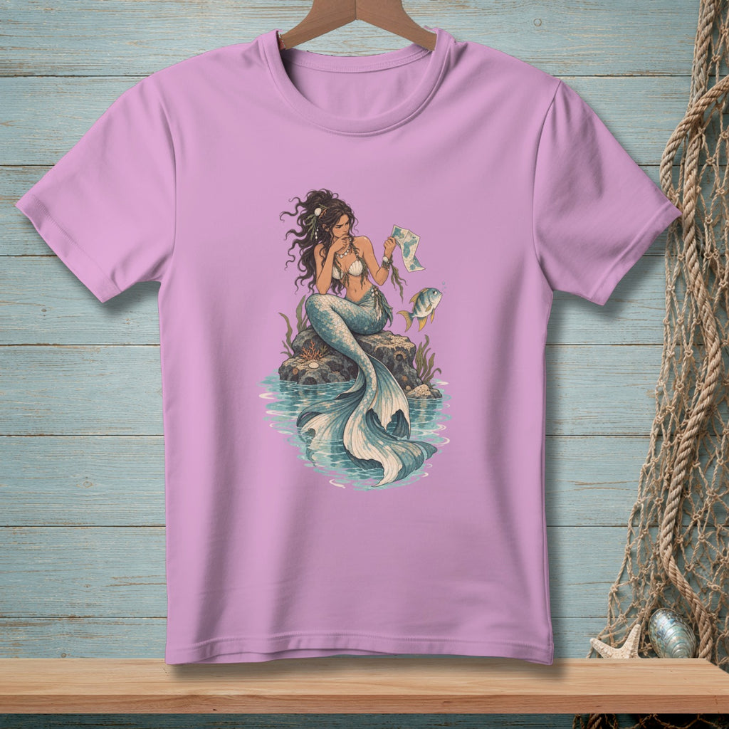 Mermaid sitting on a rock holding a map with a fish nearby.