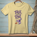 Yellow t-shirt with purple text "TALK TO THE TAIL" and a mermaid tail and crab.