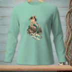 Mint long-sleeve shirt with a mermaid graphic on a rock in the ocean.