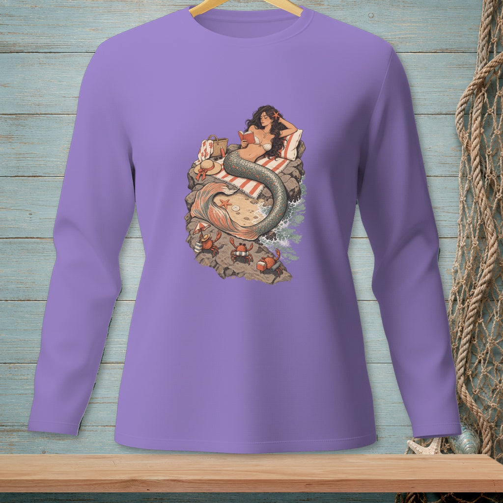 Mermaid reading on a beach with crabs, on a purple long-sleeve shirt.