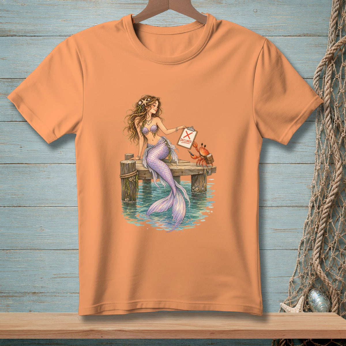 Mermaid with clipboard showing "DECLINED" next to a crab on a pier.