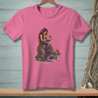 Pink t-shirt with illustration of a mermaid reading by the sea with crabs.