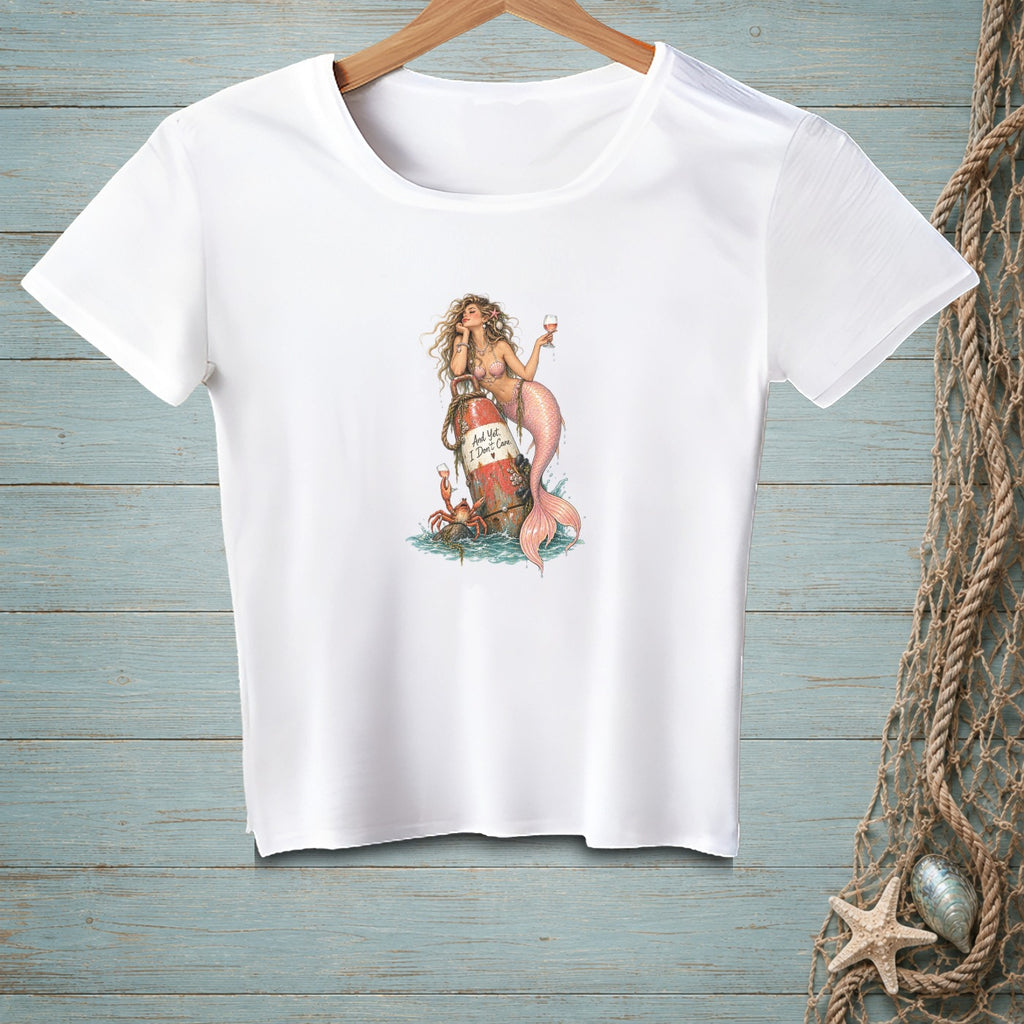 White t-shirt with mermaid on buoy, holding wine, and text "And Yet, I Don't Care".