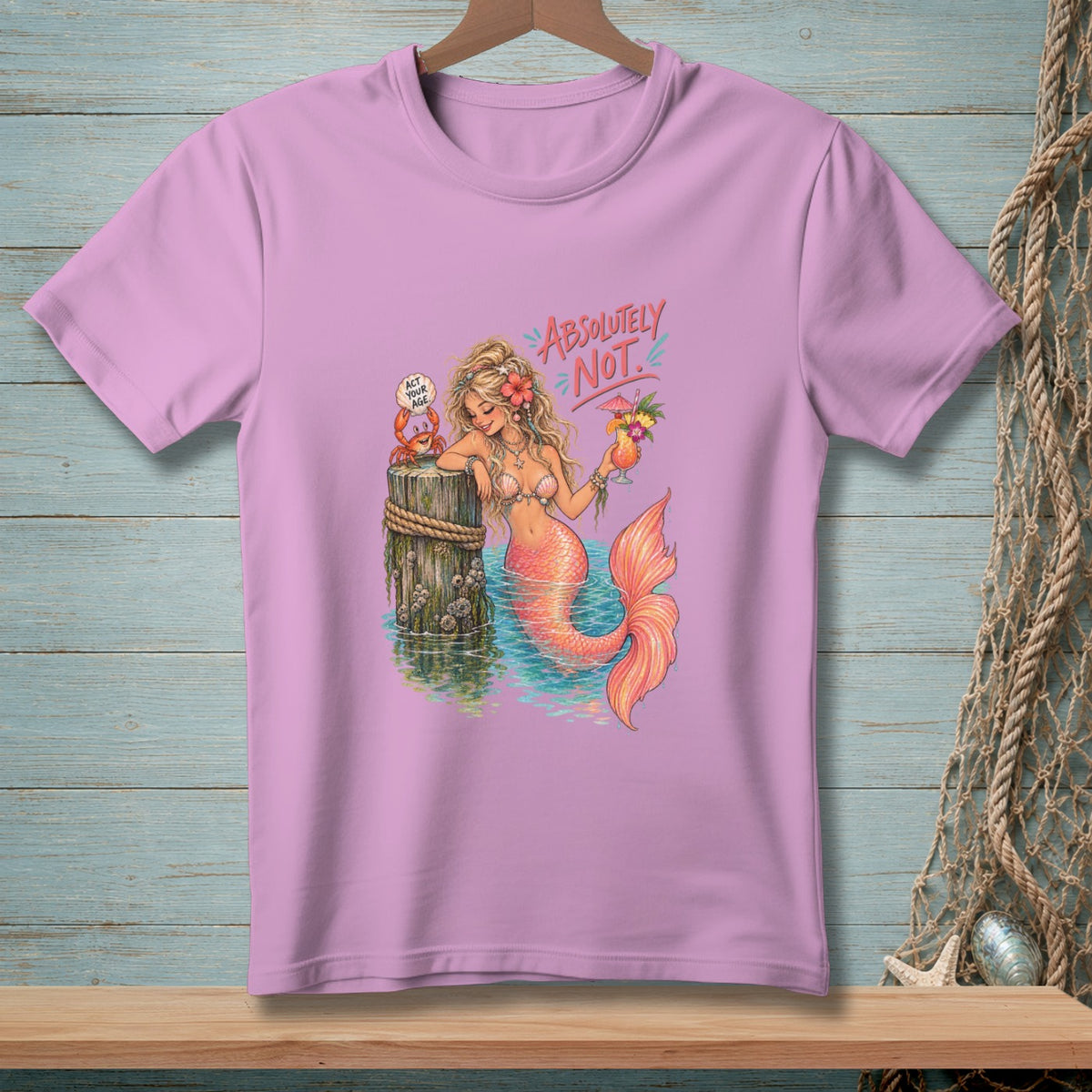 Mermaid with cocktail and crab saying "Act your age", on a pink shirt.