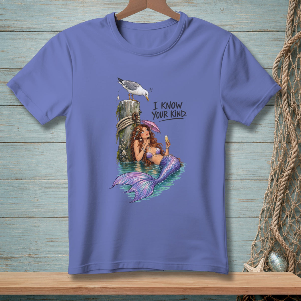Mermaid with pink umbrella and drink next to pier post with seagull, text "I KNOW YOUR KIND."