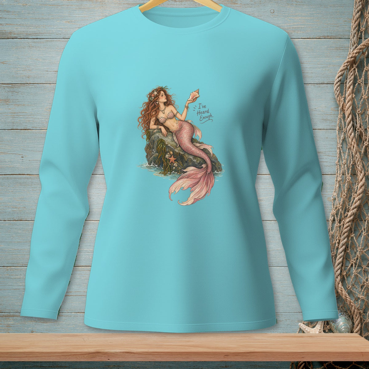 Turquoise long-sleeve shirt with a mermaid holding a seashell and the text "I've Heard Enough."