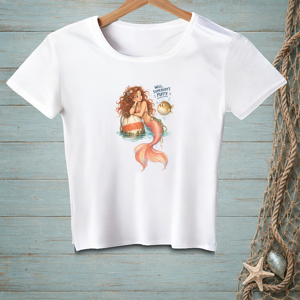 White t-shirt with mermaid and pufferfish graphic reading "Well, Somebody's Puffy."