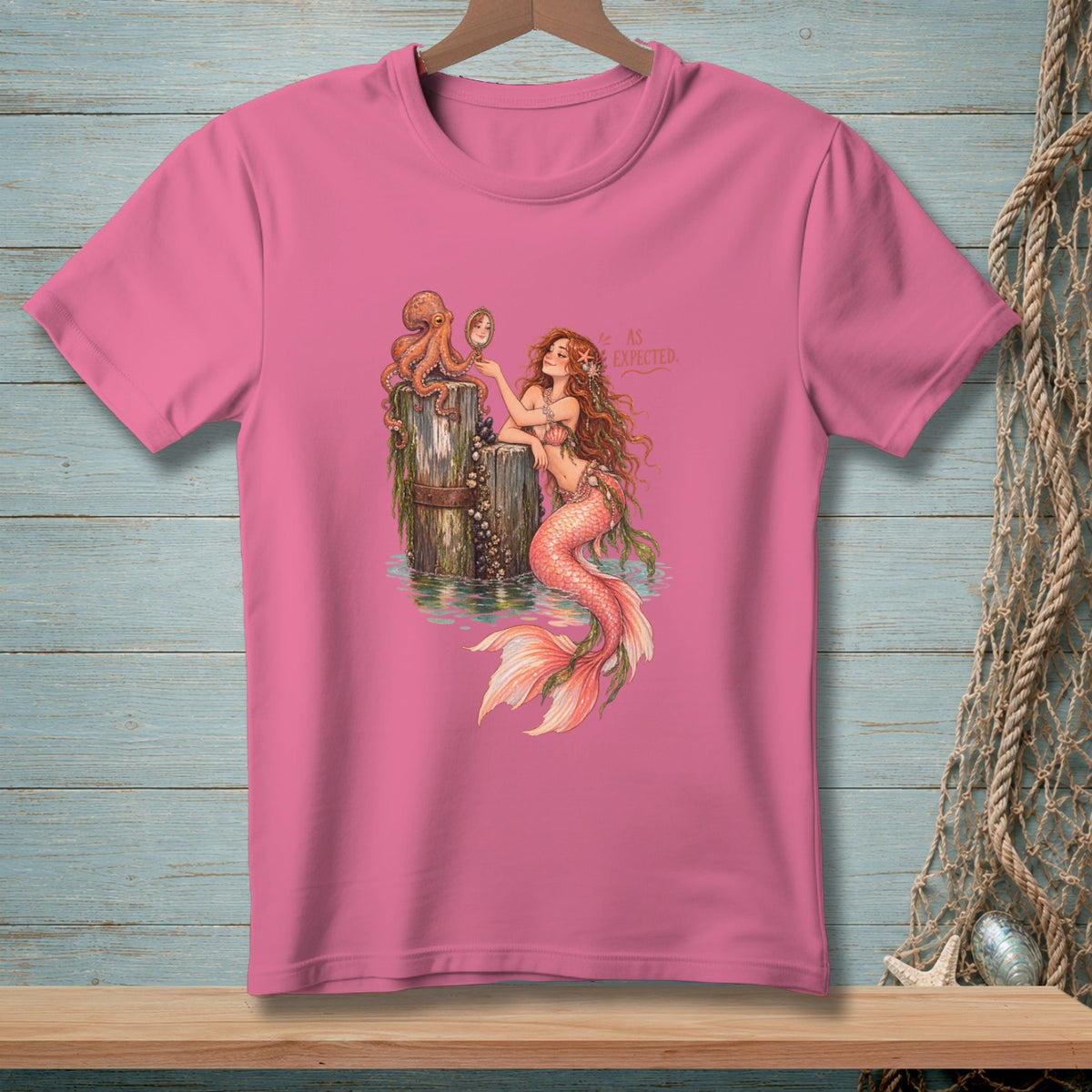 Pink t-shirt with mermaid, octopus, and mirror graphic with "AS EXPECTED" text.