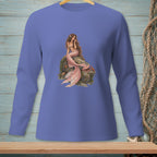 Purple long-sleeved shirt with a detailed mermaid graphic sitting on a rock.