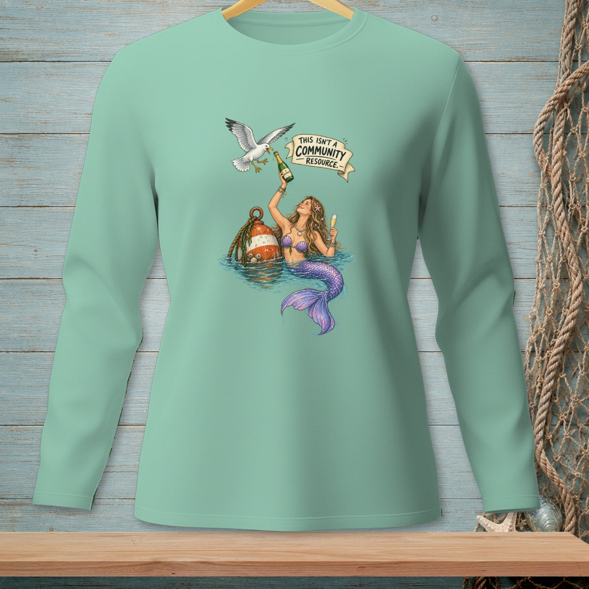 Mermaid with champagne and a seagull under banner "THIS ISN'T A COMMUNITY RESOURCE."