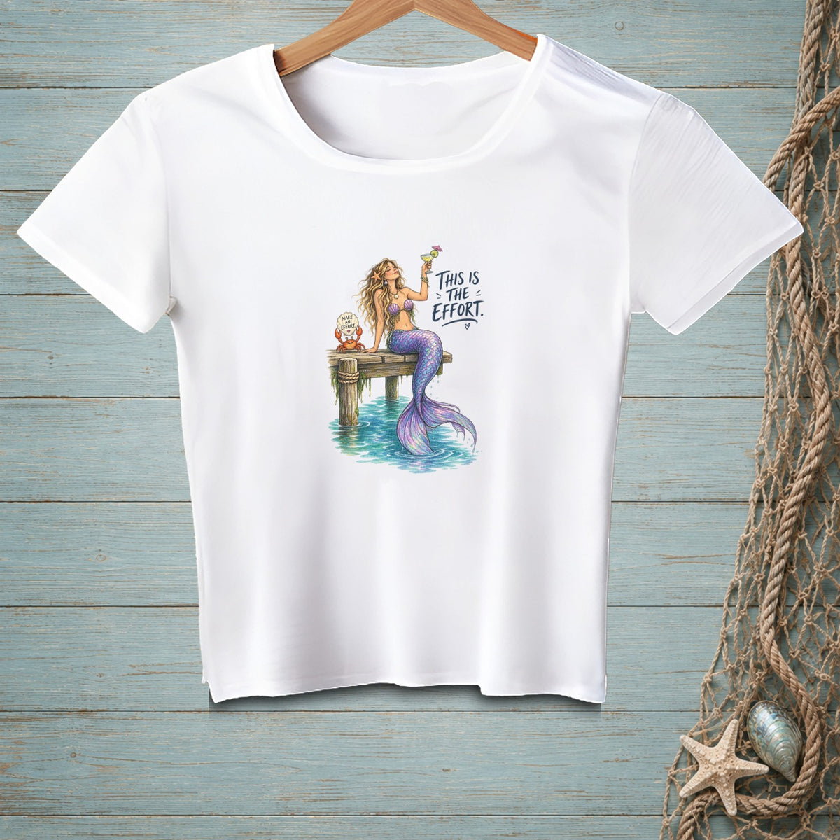 White t-shirt with a mermaid holding a drink and text "This is the effort".