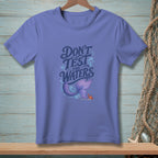 Periwinkle t-shirt with "DON'T TEST THE WATERS" text and mermaid tail graphic.