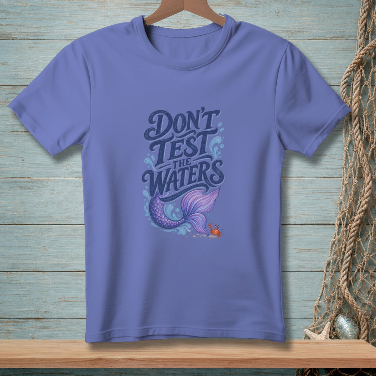 Periwinkle t-shirt with "DON'T TEST THE WATERS" text and mermaid tail graphic.