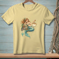 Yellow t-shirt with a drawing of a mermaid and a pufferfish.