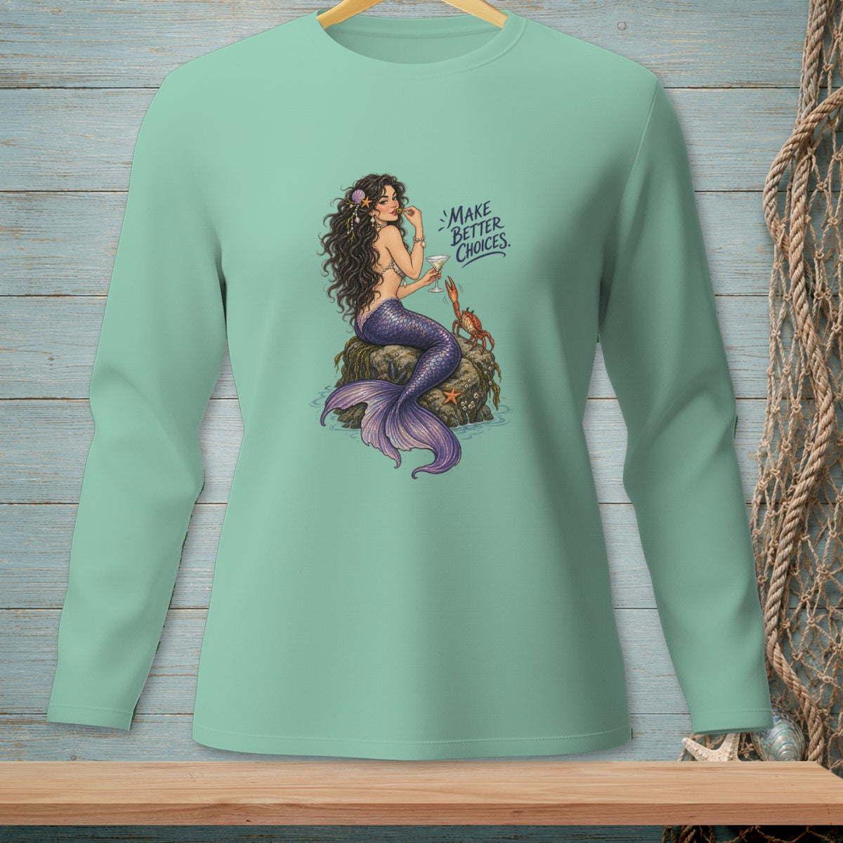 Mint green long-sleeve shirt with a mermaid, crab, starfish, and text.