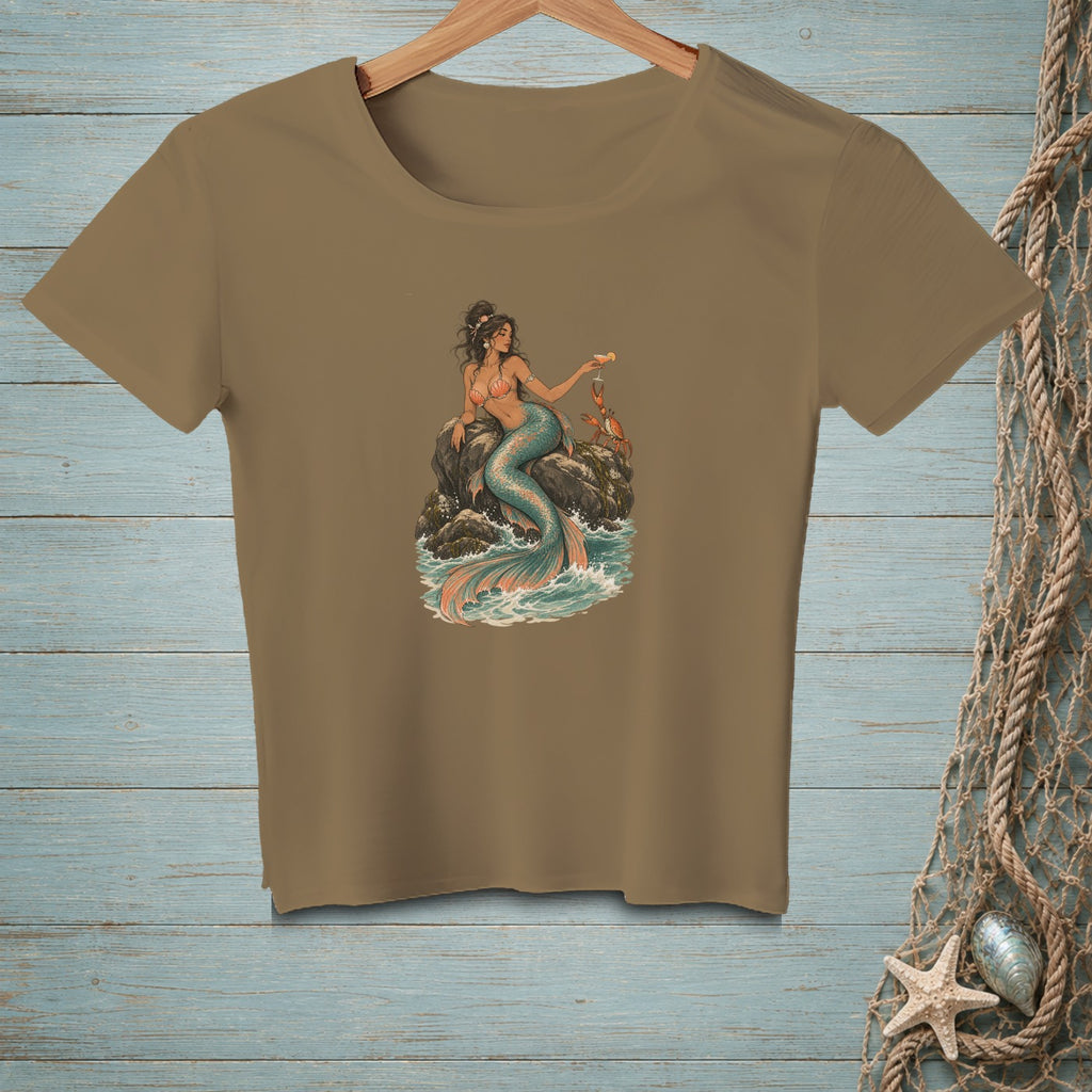 T-shirt graphic of a mermaid with a crab on a rock in the ocean.