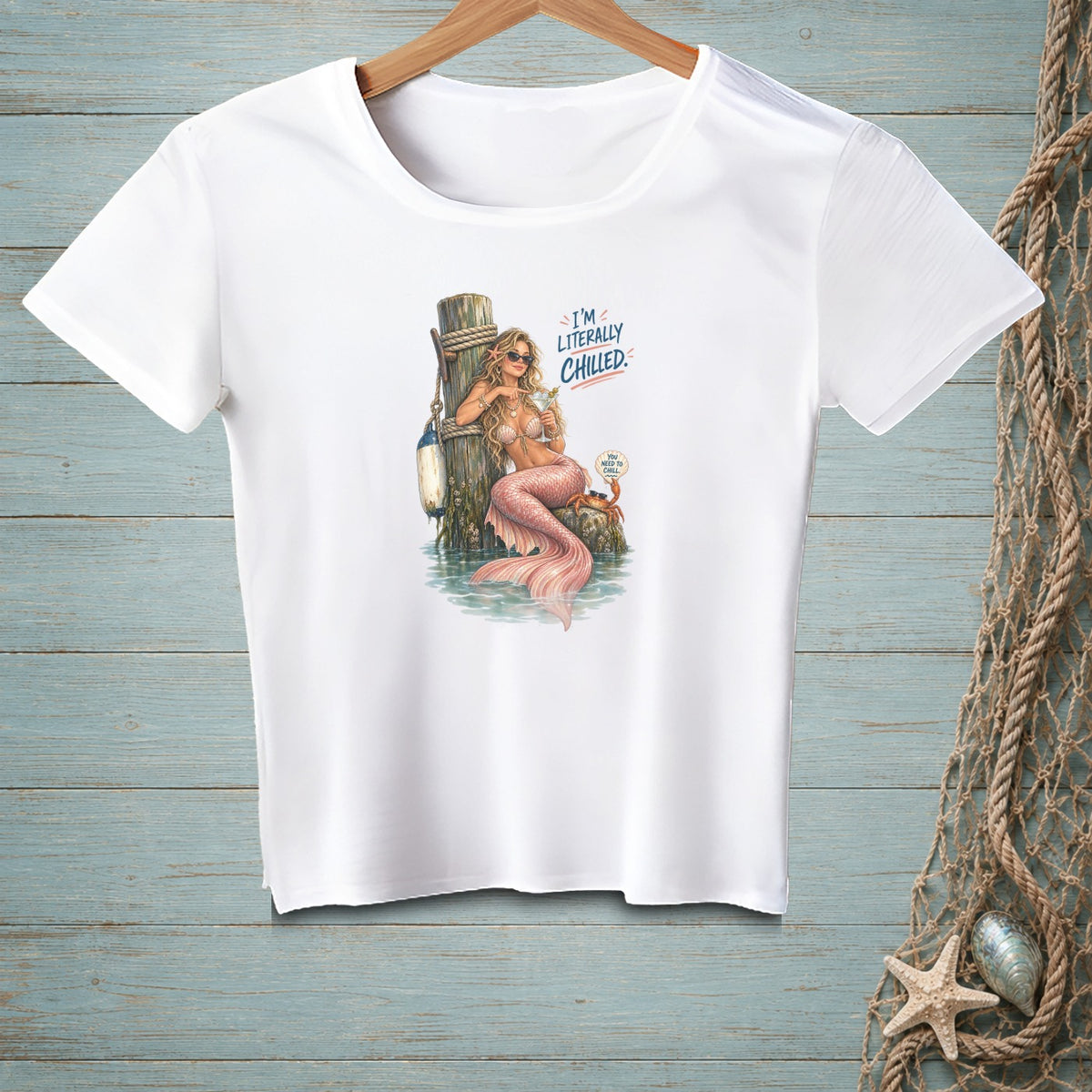 White t-shirt with a mermaid design and text "I'M LITERALLY CHILLED".