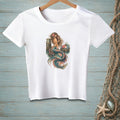 White t-shirt with a colorful mermaid graphic sitting on a wooden post.