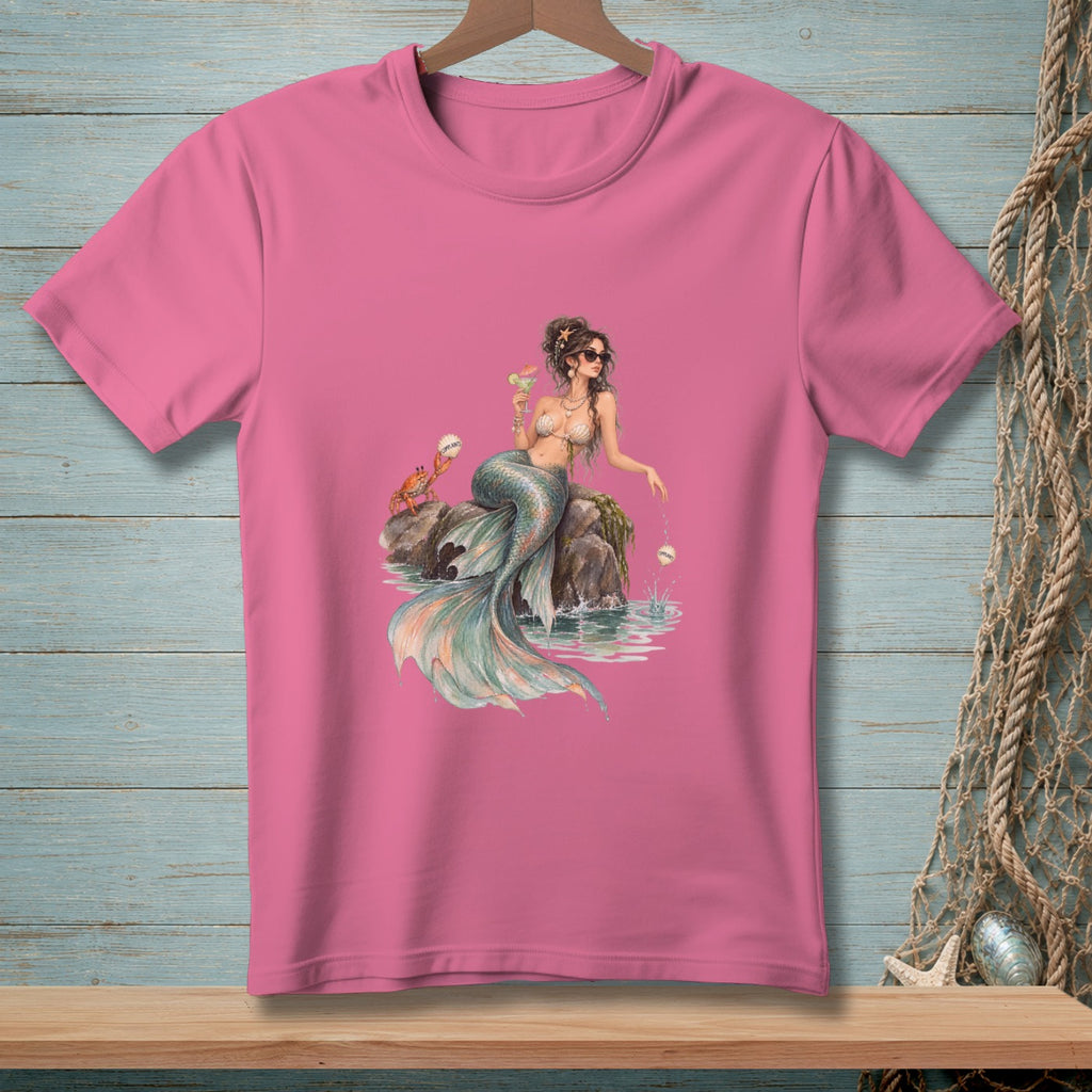 Pink t-shirt with a watercolor illustration of a mermaid with a crab and drink.