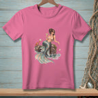 Pink t-shirt with a watercolor illustration of a mermaid with a crab and drink.