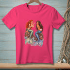 Two mermaids sit on rocks, one with red hair, the other with dark hair holding a pearl.