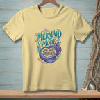 Yellow t-shirt with "Mermaid Mode: Do Not Disturb" text and mermaid tail graphic.