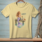 T-shirt with a mermaid holding wine and a crab on a dock, text "HANDLED".
