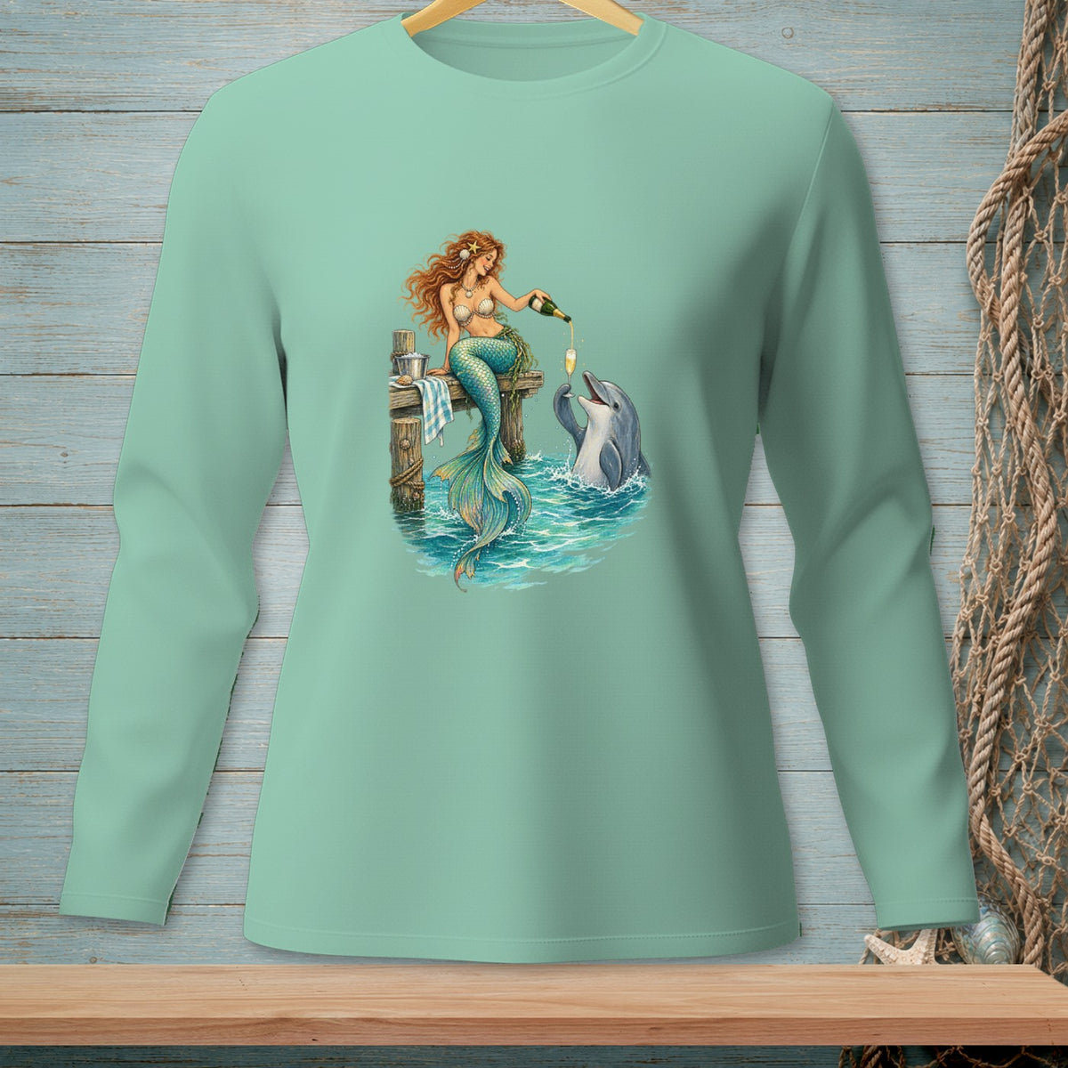 Mermaid pouring champagne for dolphin on wooden pier with ocean waves.