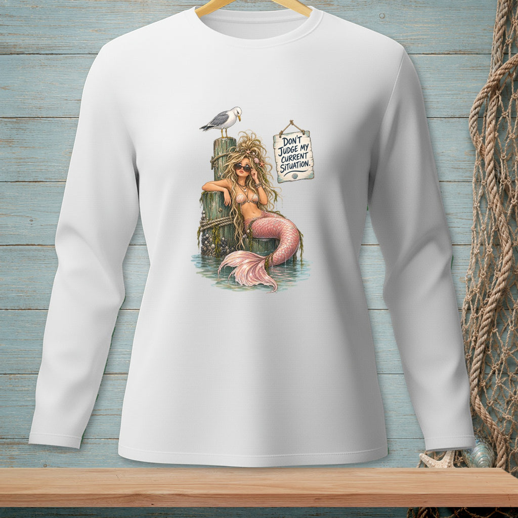 White long-sleeve shirt with a mermaid graphic and text: "Don't Judge My Current Situation."