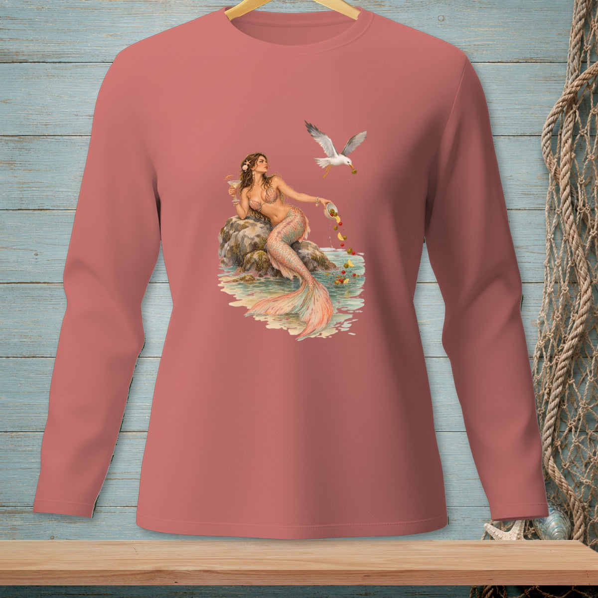 Pink long-sleeved shirt with a mermaid and seagull graphic.