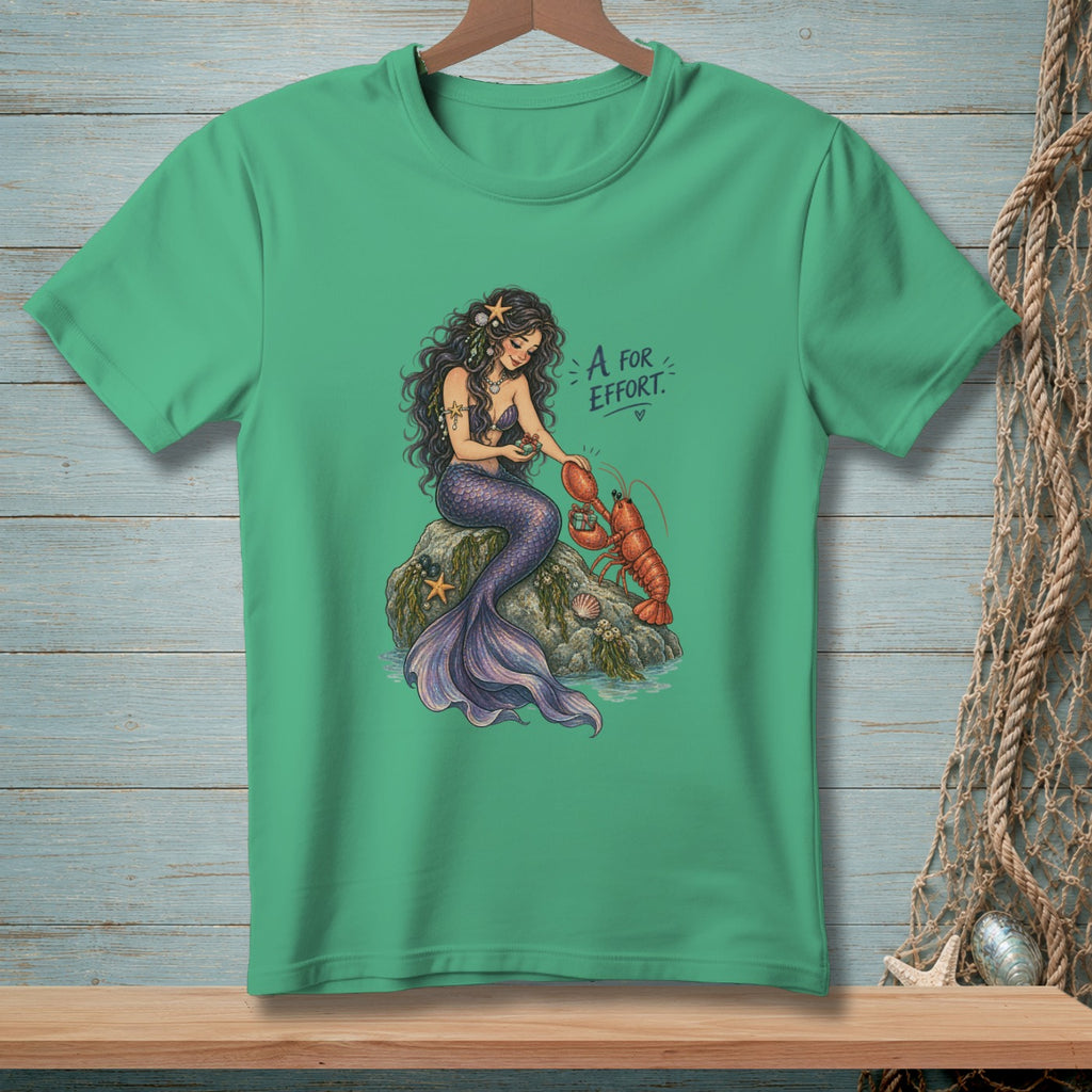 Mermaid on a rock with a lobster, text "A for Effort" with a heart.