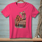 Pink t-shirt with mermaid on pier, reads "Whatever Floats Your Boat."
