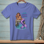 Mermaid drinking from coconut on pier with text "Salty, Tangled & Unbothered".