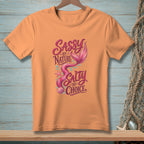 Orange t-shirt with a mermaid graphic and text "Sassy by Nature, Salty by Choice".